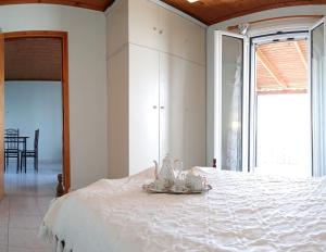 a bedroom with a white bed with a plate on it at Xigia hideaway - panoramic sea view house in Zakynthos Town