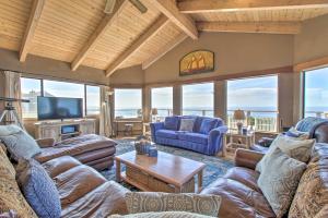 a living room with couches and a tv and windows at Spectacular Ocean View Retreat with Private Beach in Manchester