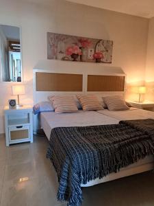 a bedroom with a large bed with two pillows at Los Hibiscos 406 in Costa Calma