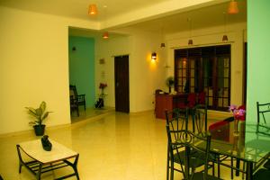 a living room with a glass table and chairs at Blue Waves Madiha in Matara