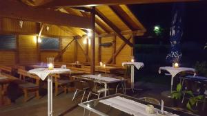 a restaurant with tables with candles on them at night at Hubertushof in Trattenbach