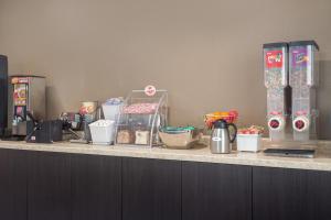 a counter top with various food items on it at Super 8 by Wyndham Eau Claire I-94 in Eau Claire