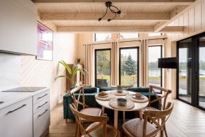 a kitchen and living room with a table and chairs at Wy_spa_Podolany in Gdów