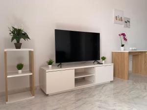 a white entertainment center with a flat screen tv at El Olivo House A in San Isidro