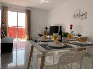 a dining room with a table with glasses of wine at El Olivo House A in San Isidro