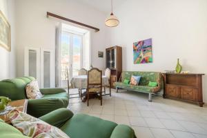 a living room with green furniture and a table at Il Soffione Centro Storico in Salerno