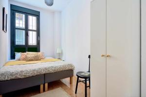 a bedroom with a bed and a window at Under the Olive Trees in Historic Center of Malaga in Málaga