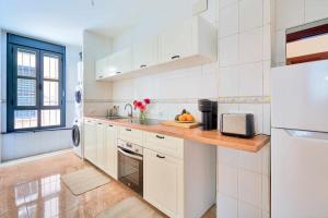 a kitchen with white cabinets and a counter top at Under the Olive Trees in Historic Center of Malaga in Málaga
