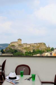 a table and chairs with a view of a castle at Hôtel Florida in Lourdes