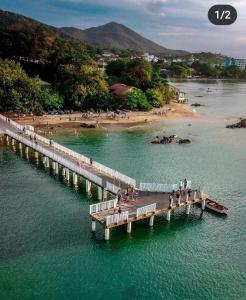 a bridge over a body of water with a beach at Beach House in Penha