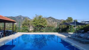 a swimming pool with mountains in the background at Limeria in Alona
