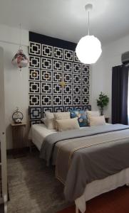 a bedroom with two beds and a black and white wall at Maya Homestay Putrajaya Unit Dua in Putrajaya