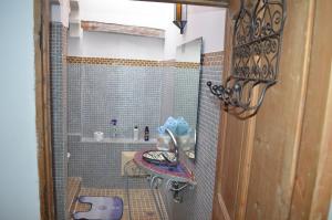 een kleine badkamer met een wastafel en een douche bij Riad Kasbah in Rabat