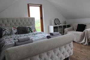a bedroom with a bed with two pillows on it at The Loft at Rock Cottage with hot tub in Garvagh
