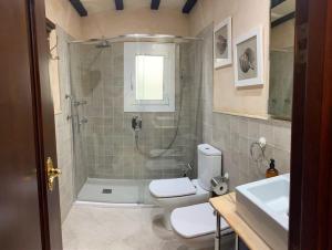 a bathroom with a shower and a toilet and a sink at La Pastora Apartamento con parking in Gavà +42 photos