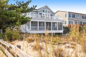 a large house on the beach with a fence at Middlesex Beach -- 30 Dune in South Bethany