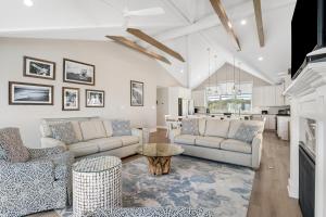 a living room with two couches and a table at Middlesex Beach -- 30 Dune in South Bethany