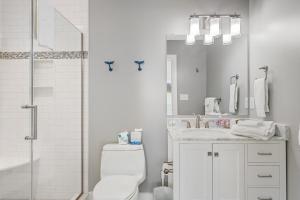 a bathroom with a toilet and a sink and a shower at Middlesex Beach -- 30 Dune in South Bethany +30 photos