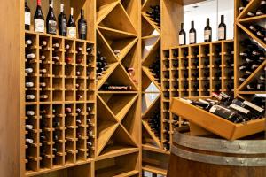 a wine cellar with wooden racks and wine bottles at Hotel Olympic Spa & Wellness in Ustroń