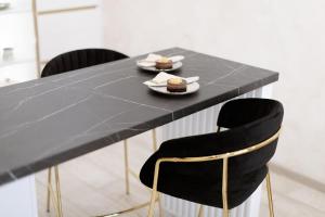 a black table with two plates of food on it at Apartman Stari Toranj III in Vukovar