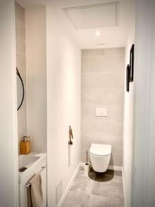 a white bathroom with a toilet and a sink at Loft Menorca & Spa 5 étoiles au cœur de Nancy in Nancy +27 photos