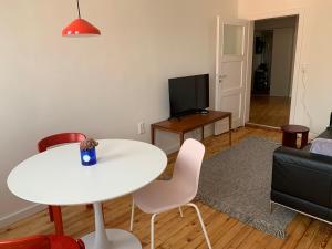 a living room with a white table and chairs at Charmante Stadtwohnung im Textilviertel in Augsburg