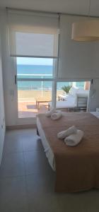 a bedroom with a bed and a view of the beach at MIRADOR in Denia