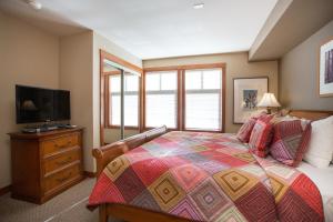 a bedroom with a bed and a flat screen tv at 1202 - Two Bedroom Standard Eagle Springs West condo in Solitude +7 photos