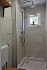 een badkamer met een douche en een bad bij Het Zwarte Paard in Gameren