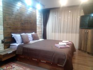 1 dormitorio con 1 cama grande y TV de pantalla plana en КръчмЪ при Байката Alpin, en Ribaritsa