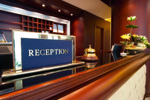a hotel reception desk with a sign that reads reception at Relais Sans Soucis & Spa in Ronciglione
