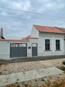 a white house with a red roof at Dream Apartman in Levél