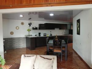 a living room with a table and a kitchen at Refugio Sereno en Cartago B&B in Cartago