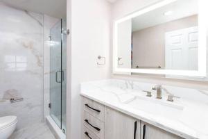 a bathroom with two sinks and a shower and a mirror at WESTGATE PALACE RESORT in Orlando