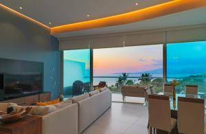 Una sala de estar con un sofá y vista al mar. en Marítima Playa Beach front Condo with great views, en Nuevo Vallarta 