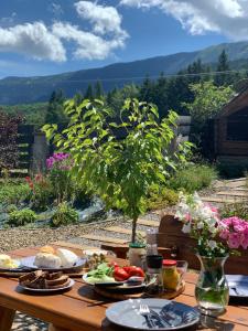 a wooden table with plates of food on it at Babie Zacisze in Zawoja