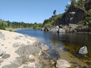 a river with rocks on the side of a mountain at Bela Vista Casa Serrana, Golpe de Agua in Los Reartes +52 photos