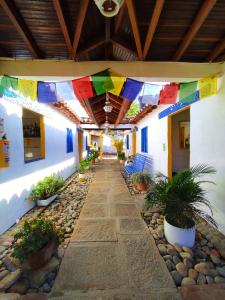 a patio with colorful flags hanging from a building at Hostel Trip Monkey Barichara in Barichara