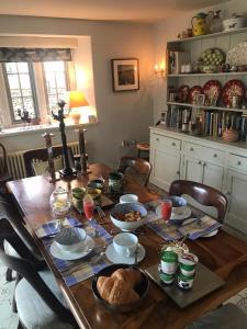 a dining room table with food on it at Brook House in Nunney