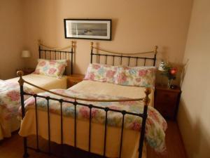 a bedroom with two beds and a picture on the wall at The Waters Edge in Aughris