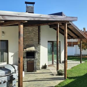 a wooden pergola in front of a house at Villa Gardenia in Sapareva Banya