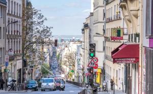 una concurrida calle de la ciudad con coches y semáforos en Jacuzzi LOVE appartement en París