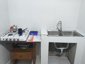 a kitchen with a sink and a stove at Family Hotel "Big House" in Kobuleti