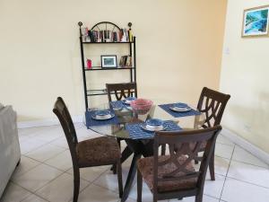 a dining room with a table and chairs at 25 Margate Gardens in Bridgetown