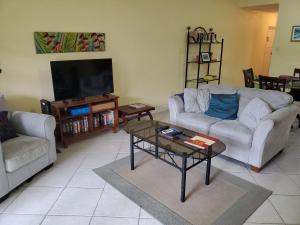 a living room with two couches and a coffee table at 25 Margate Gardens in Bridgetown