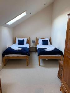 a bedroom with two beds in a room at The Cottage, Hill Top Stables in Esh