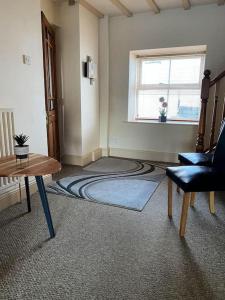 a living room with a rug on the floor at The Cottage, Hill Top Stables in Esh