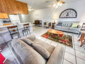 a living room with a couch and a kitchen at Comal River Condo 373 in New Braunfels