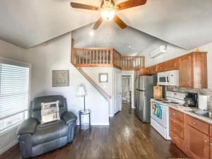 a kitchen with a ceiling fan and a living room at Magnolia Creek Haus on River Road in New Braunfels