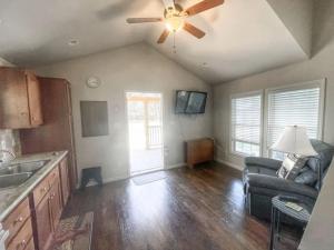 a kitchen with a ceiling fan and a living room at Magnolia Creek Haus on River Road in New Braunfels